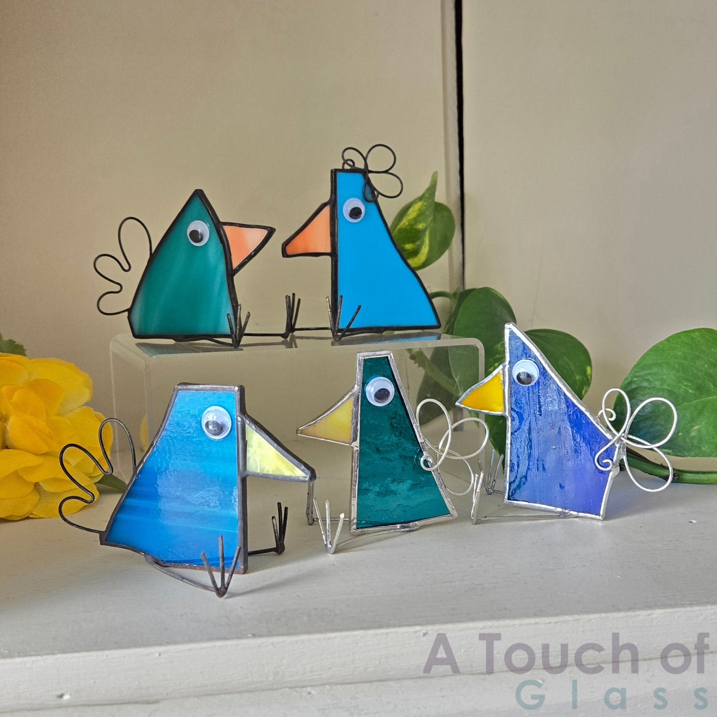 The whimsical scrap glass bird is colourful, charming and imaginative exuding a playful and fanciful aura with its quirky design and delightful character. Sold individually blue tones in various shapes.
