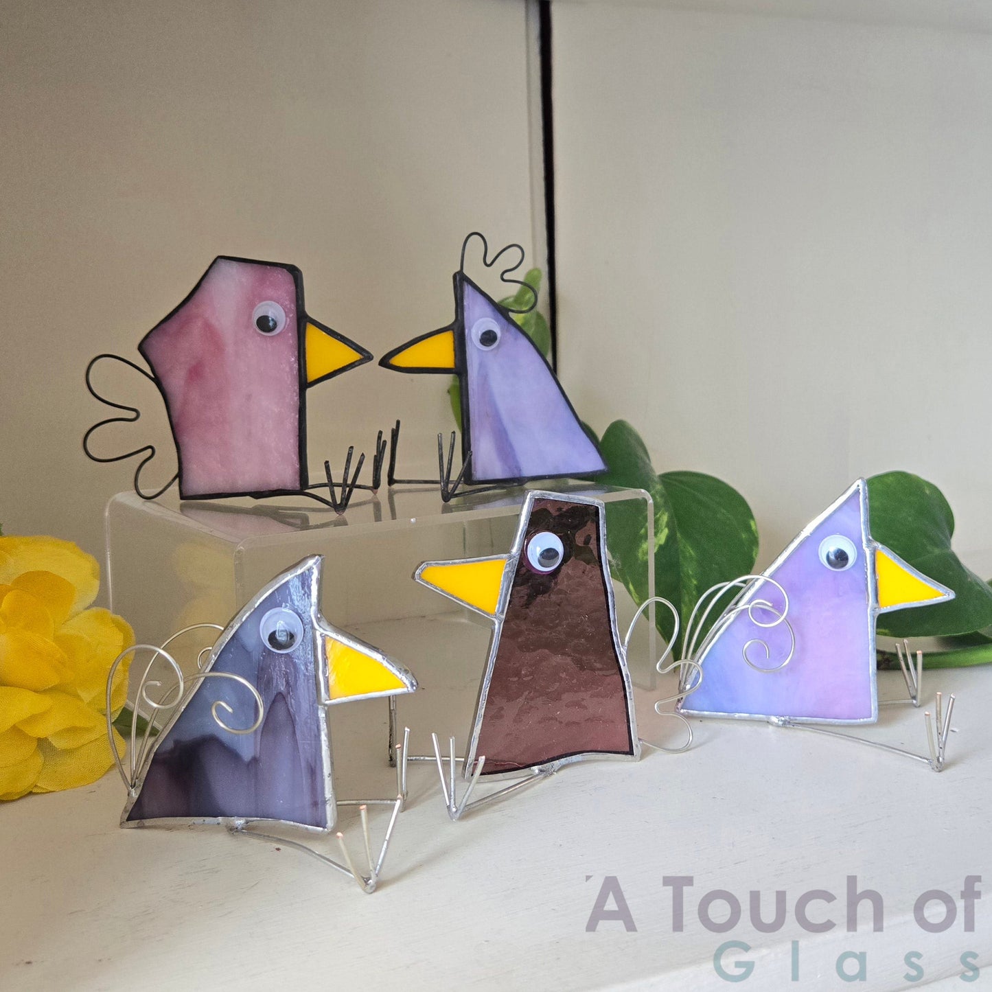 The whimsical scrap glass bird is colourful, charming and imaginative exuding a playful and fanciful aura with its quirky design and delightful character. Sold individually purple tones in various shapes.