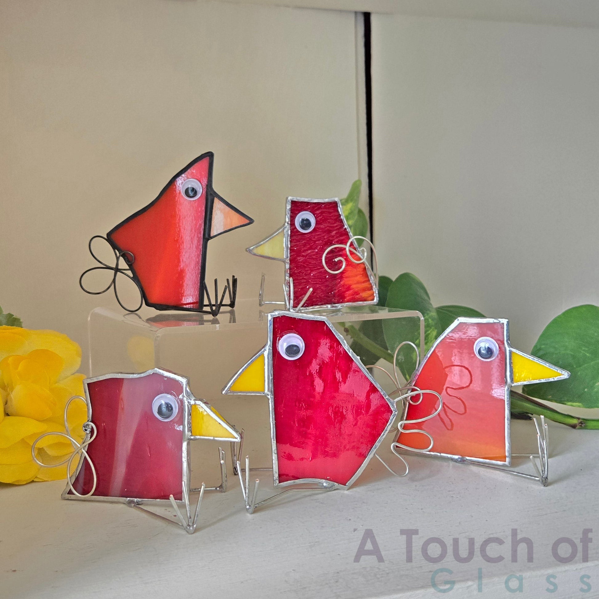 The whimsical scrap glass bird is colourful, charming and imaginative exuding a playful and fanciful aura with its quirky design and delightful character. Sold individually red tones in various shapes.