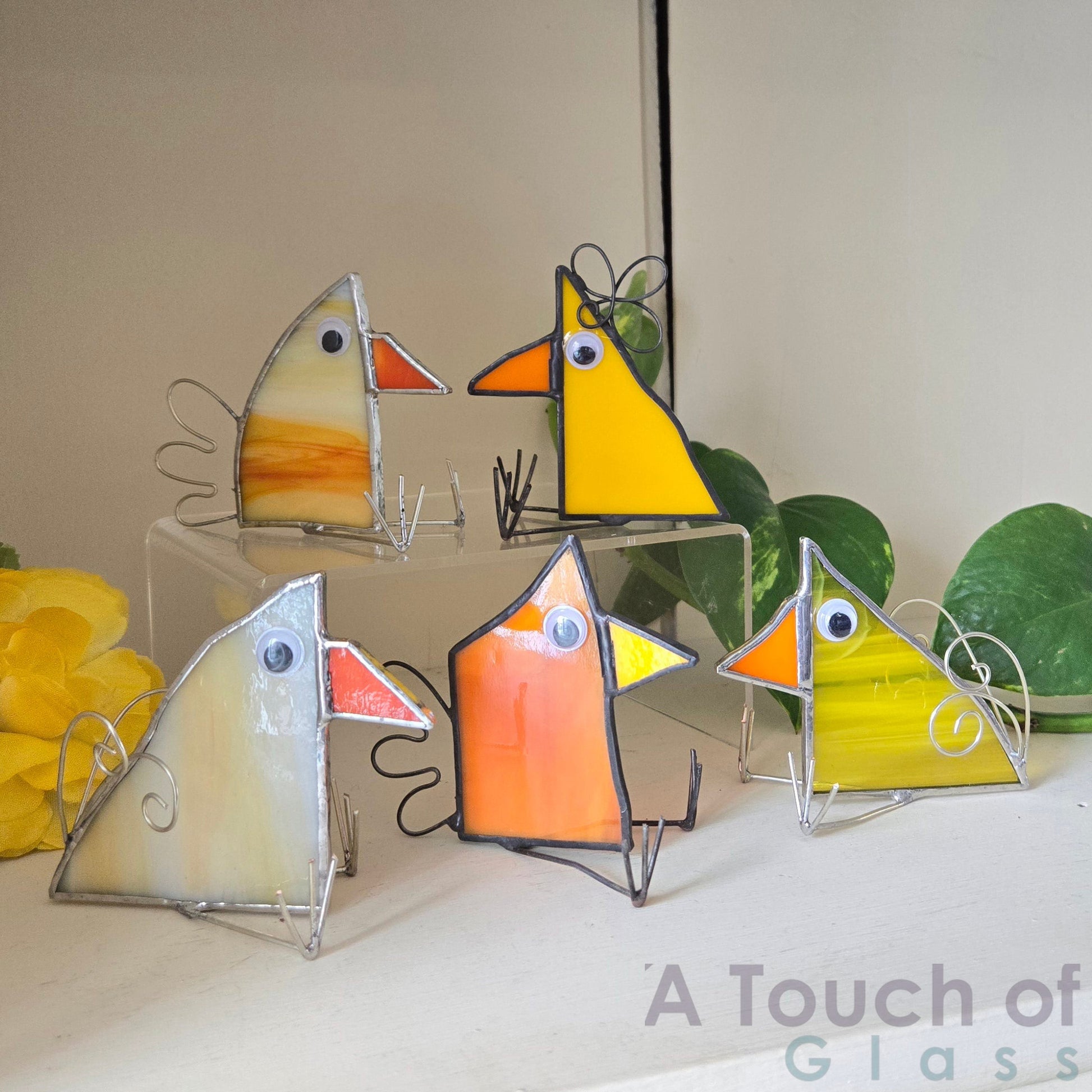 The whimsical scrap glass bird is colourful, charming and imaginative exuding a playful and fanciful aura with its quirky design and delightful character. Sold individually yellow tones in various shapes.